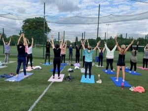 yoga participants on their mats outside