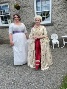 Tow ladies in period dress outside the Maria Edgeworth Centre