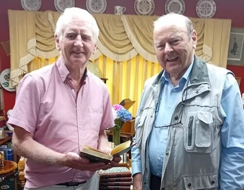 Eamonn de Burca gifting books to Matt Farrell