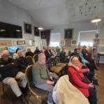 A group waiting to hear a talk on Regency Fashion