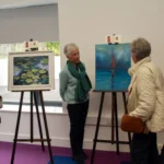Three woman looking at art n an exhibition