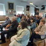 A group of people listening to an author talk about Regency Romance
