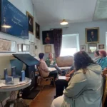 A group of people listening to an author talk about Regency Romance