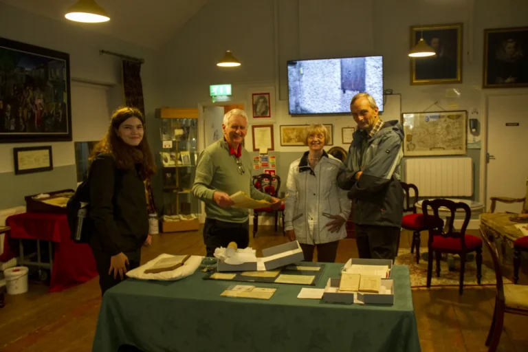 Visitors looking at objects in the museum
